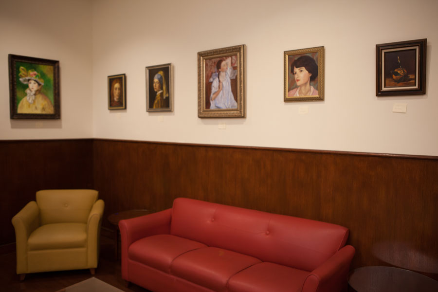 Art gallery featuring six portraits on a wooden wall